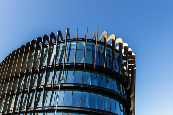 The outside of the top of Huddersfield University's Building showcasing large glass panelling.