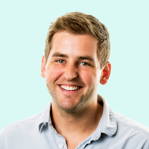 A man with short brown hair smiling, aged 20s-30s.